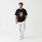 Man wearing a black t-shirt with a graphic design on a white background
