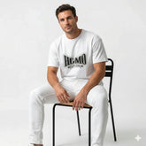 Person wearing a white t-shirt with 'HOMO SAPIENS' text on a dark background