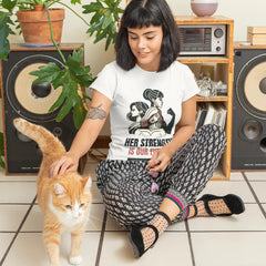 Woman sitting on the floor with a cat, surrounded by speakers and plants.