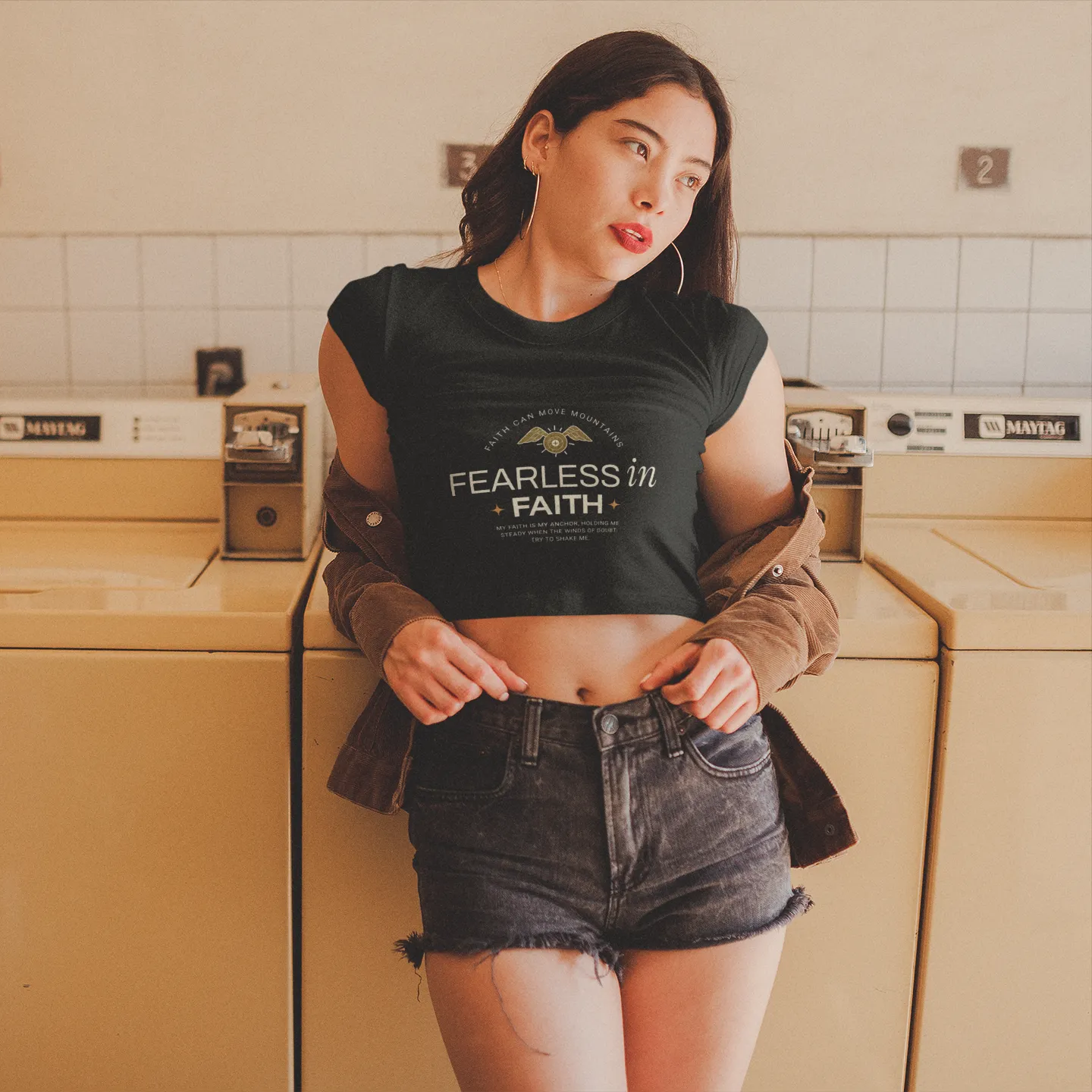 Woman wearing a black t-shirt with text in a laundry room