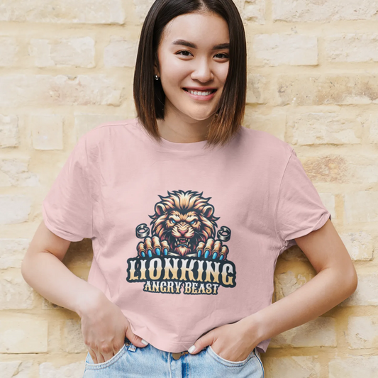 Person wearing a pink t-shirt with a lion graphic and text against a brick wall.