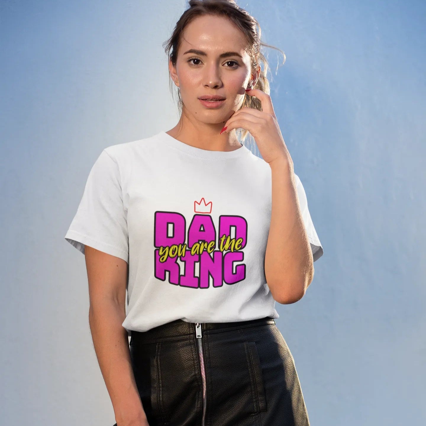 Woman wearing a white t-shirt with colorful text design against a light blue background