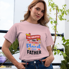 Woman wearing a pink t-shirt with a humorous message, standing outdoors with plants in the background.
