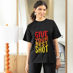 Woman wearing a black t-shirt with 'GIVE YOUR BEST SHOT' text in a room.