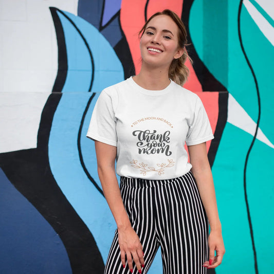 Woman wearing a white t-shirt with text in front of a colorful abstract mural