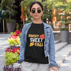 Person wearing a black t-shirt with 'Sweet Sweet Fall' text and denim jacket in an outdoor setting.