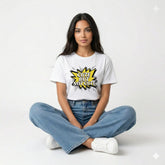 Person wearing a white t-shirt with a graphic design and text, sitting on the floor against a white background.