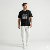 Man wearing a black t-shirt with 'Hustle Hard' text on a white background