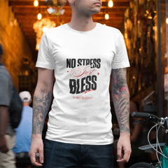Man wearing a white t-shirt with 'No Stress Just Bless' text in an urban setting.