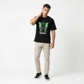 Man wearing a black t-shirt with a graphic design on a white background
