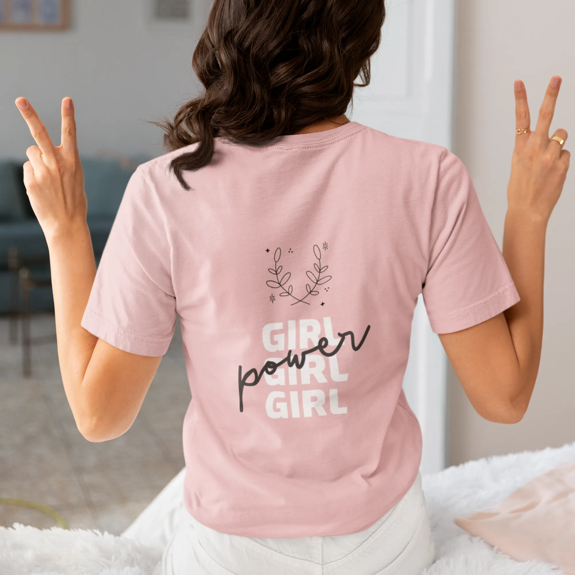 Person wearing a pink t-shirt with 'Girl power Girl Girl' text, making peace signs.