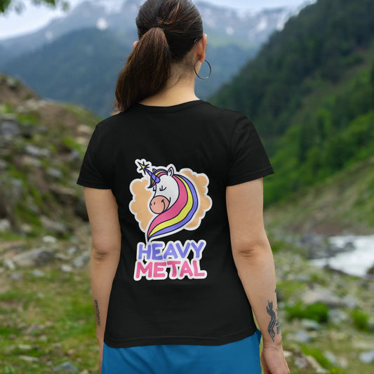 Person wearing a black t-shirt with a colorful unicorn design and 'Heavy Metal' text, standing in a mountainous landscape.