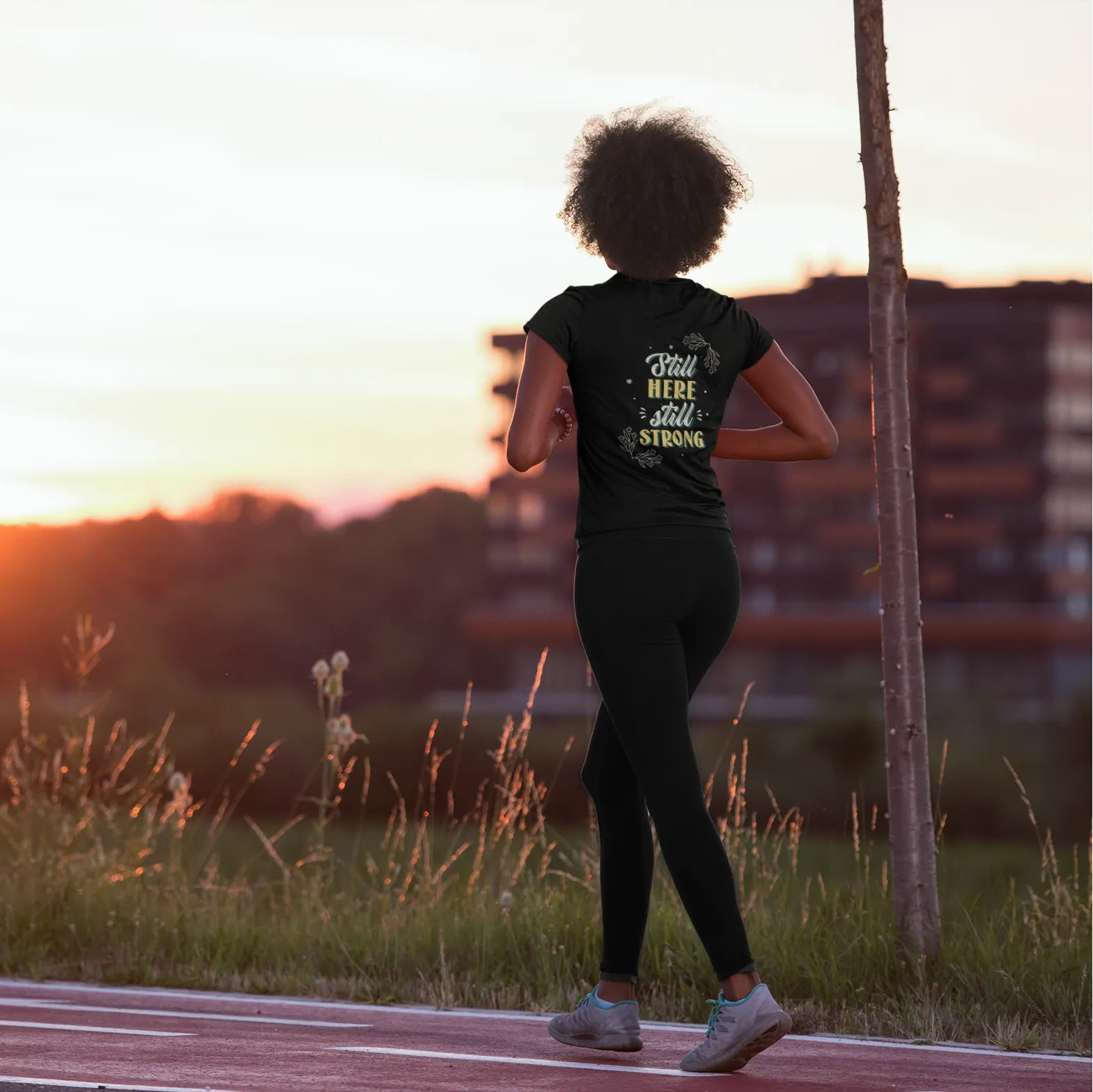 Person running on a path with a sunset in the background