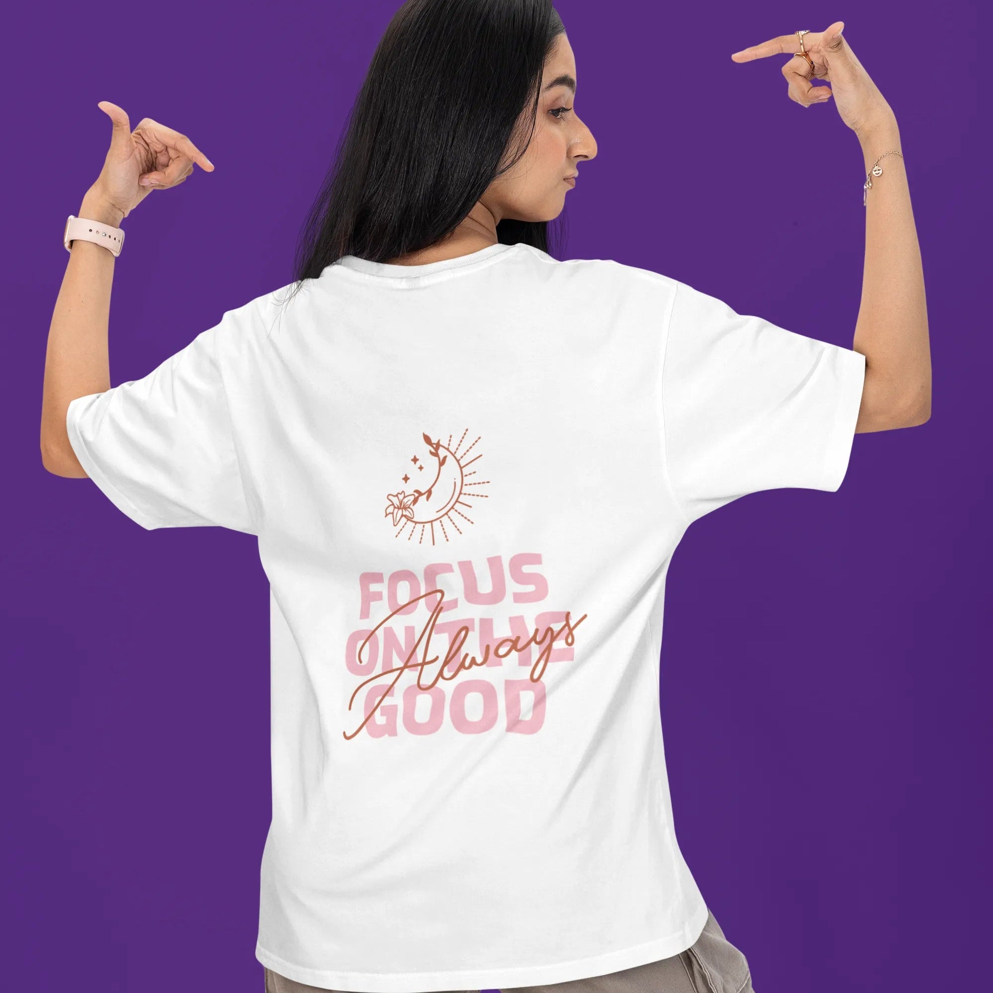 Person wearing a white t-shirt with a motivational quote on the back against a purple background