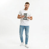 Man wearing a white t-shirt with text and light blue jeans on a white background