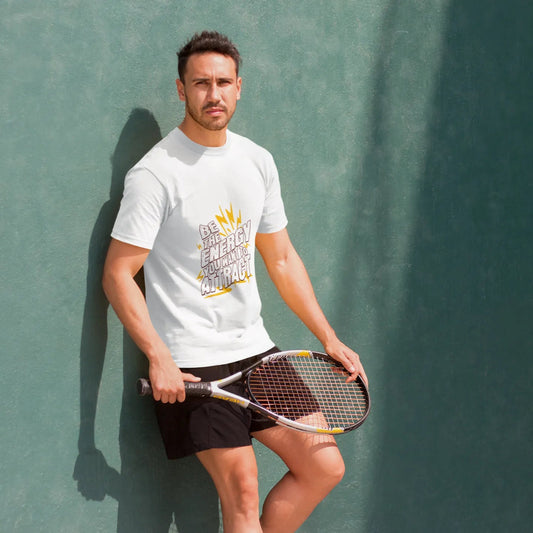 Man holding a tennis racket against a green wall
