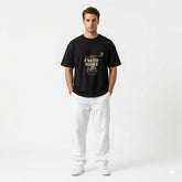 Man wearing a black t-shirt with text and graphics on a white background