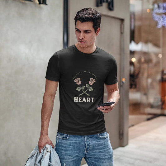 Man wearing a black t-shirt with a graphic design, standing in an urban setting.