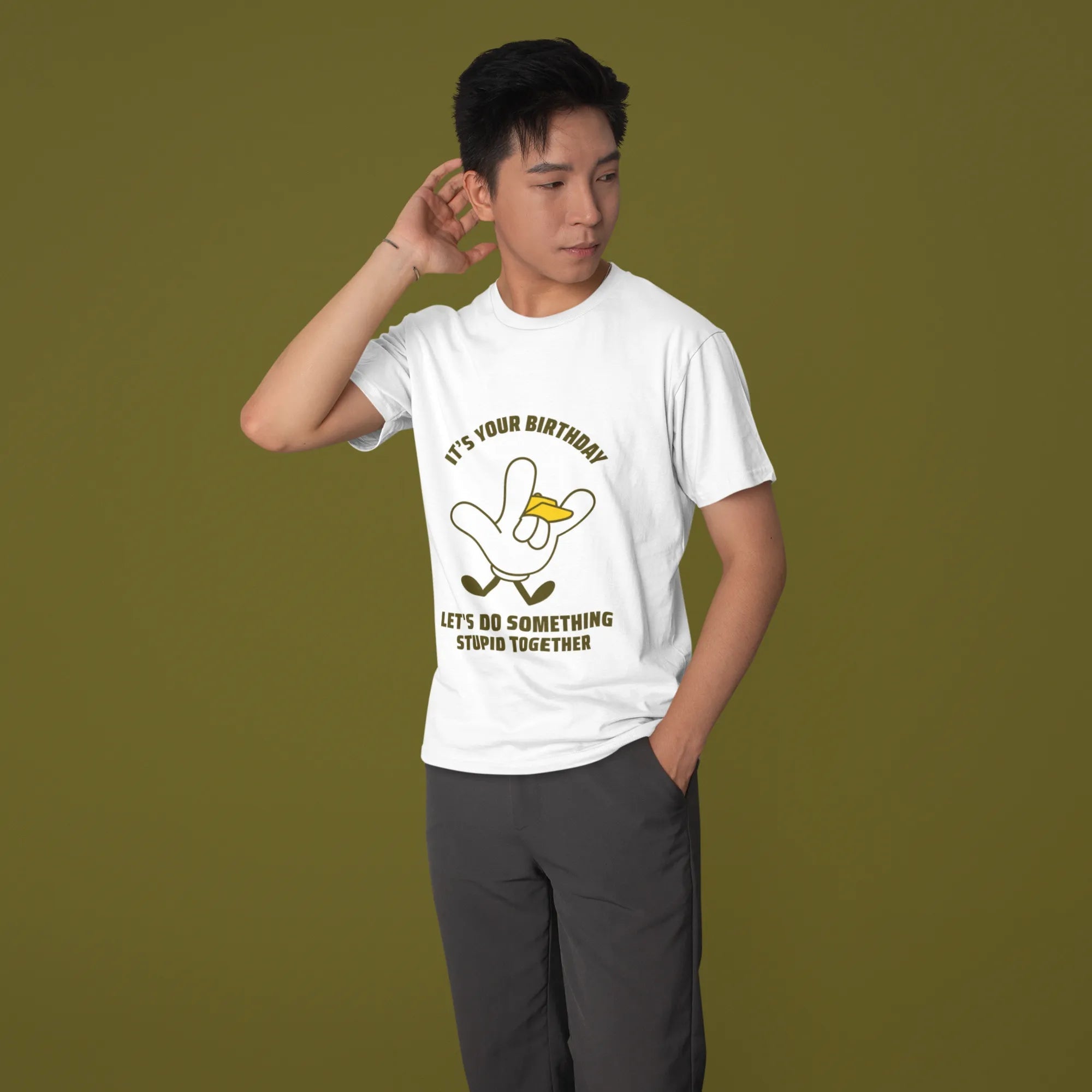 Person wearing a white t-shirt with a graphic design on a green background