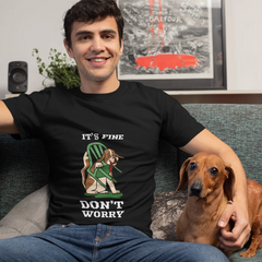 Man sitting on a couch with a dog, wearing a black t-shirt with a graphic and text.