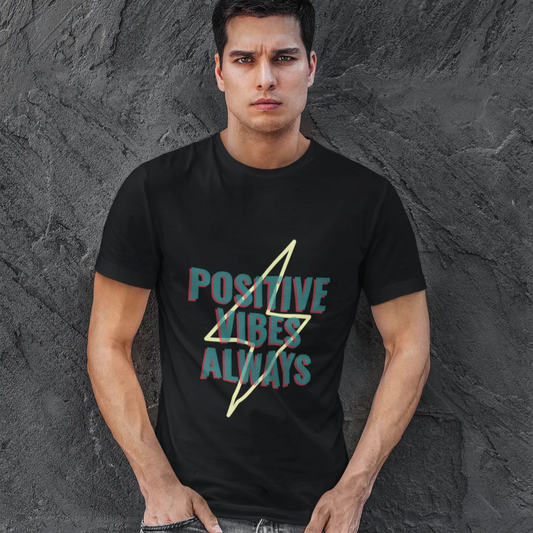 Man wearing a black t-shirt with 'Positive Vibes Always' text against a textured gray background