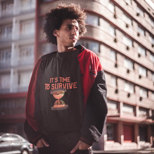 Person wearing a black and red jacket with text and graphic design, standing in front of a building.