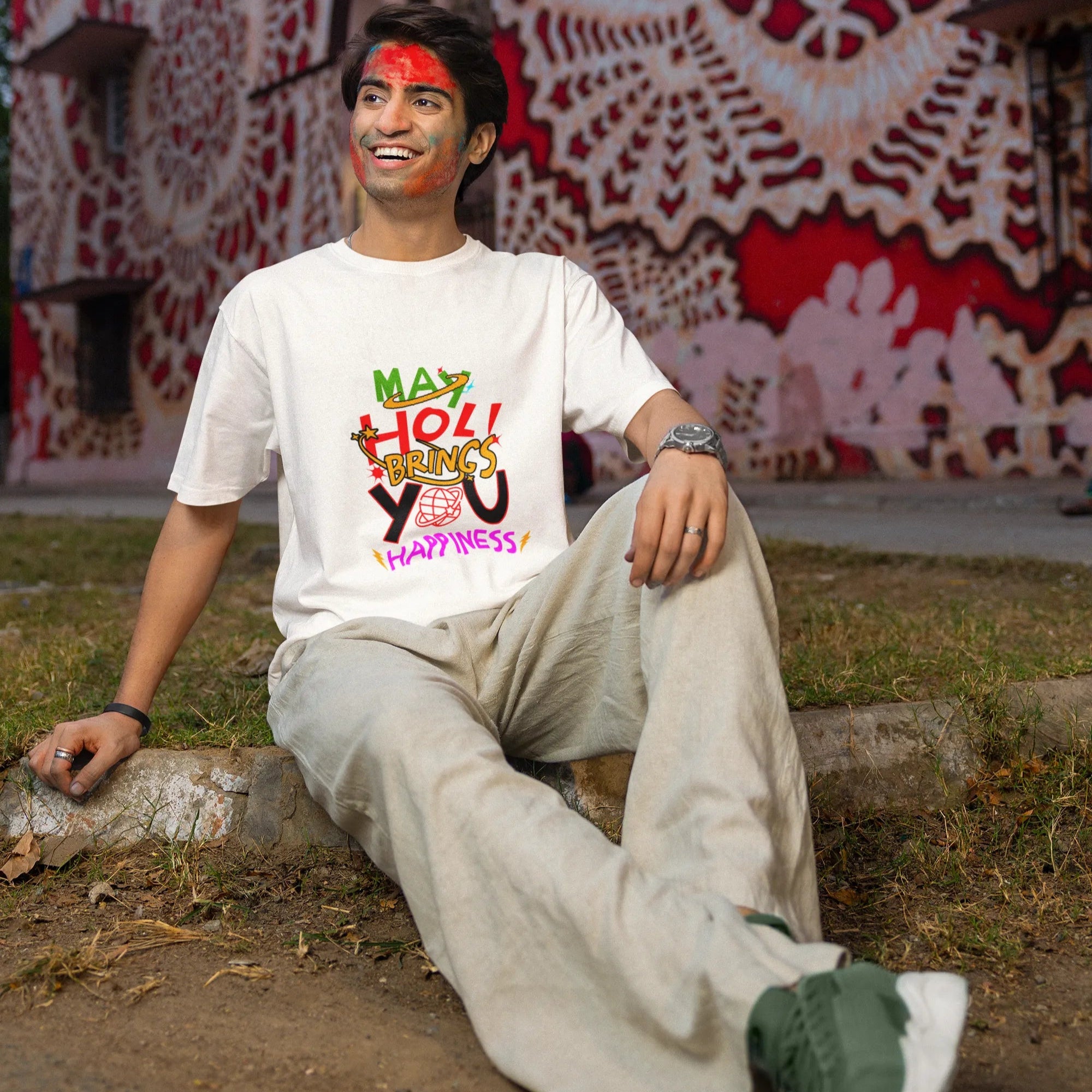 Person sitting on a ledge with colorful graffiti in the background