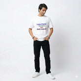 Person wearing a white t-shirt with colorful text on a white background