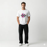 Man wearing a white t-shirt with colorful text design on a plain background
