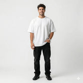 Man wearing a white t-shirt and black pants on a white background