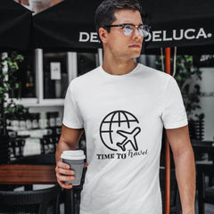 Man wearing a white t-shirt with a travel-themed design, holding a coffee cup outdoors.
