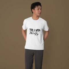 Person wearing a white t-shirt with 'Travel is my Therapy' text on a brown background