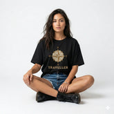 Woman wearing a black t-shirt with a compass design and 'Traveller' text on a white background