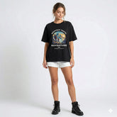 Woman wearing a black t-shirt with a mountain design and text on a white background
