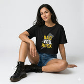 Woman wearing a black t-shirt with 'DAD YOU ROCK' text, standing outdoors.