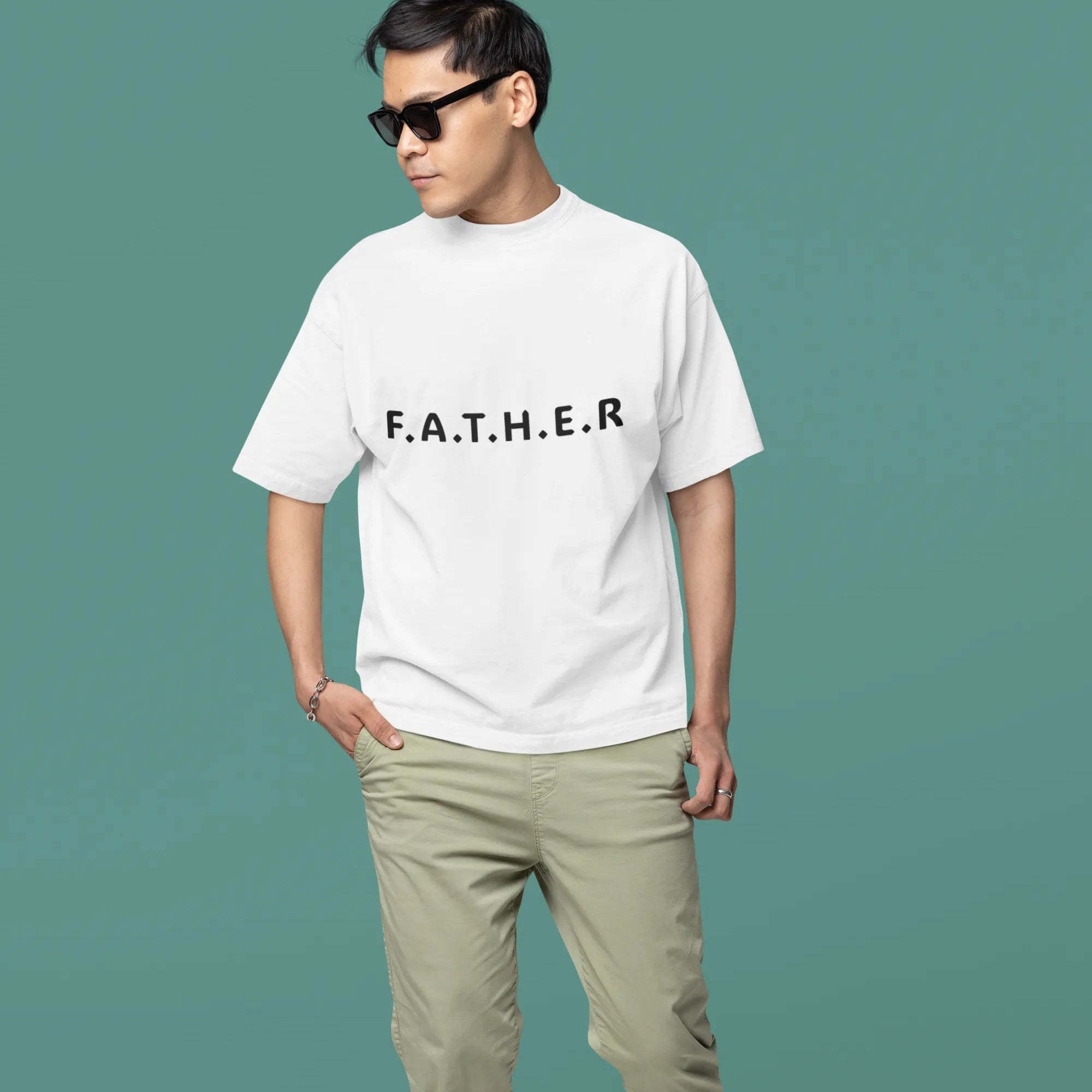 Man wearing a white t-shirt with 'F.A.T.H.E.R.' text on a teal background