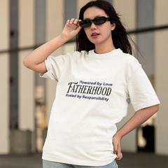 Woman wearing a white t-shirt with text, standing outdoors.