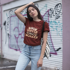 Woman wearing a red t-shirt with text, standing in front of a graffiti-covered wall.
