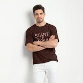 Man wearing a brown t-shirt with 'Start Today' text on a white background