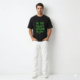 Man wearing a black t-shirt with motivational text on a white background