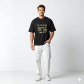 Man wearing a black t-shirt with motivational quote on a white background