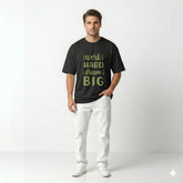 Man wearing a black t-shirt with motivational text on a white background