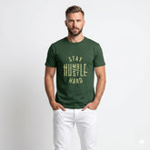 Man wearing a green t-shirt with 'Stay Humble, Hustle Hard' text on a white background