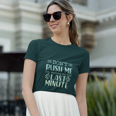 Woman wearing a green t-shirt with a humorous quote outdoors.