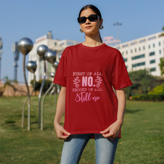 Person wearing a red t-shirt with text in an outdoor setting