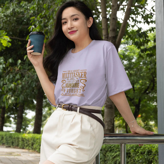 Woman holding a coffee cup outdoors with greenery in the background