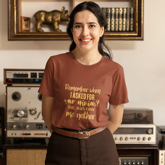 Woman wearing a brown t-shirt with text in a room with vintage equipment.