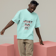 Person wearing a light blue t-shirt with 'Just Do It' text on pink blocks.