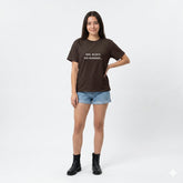 Person wearing a brown t-shirt with text on a white background