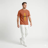 Man wearing a brown t-shirt with yellow text on a white background